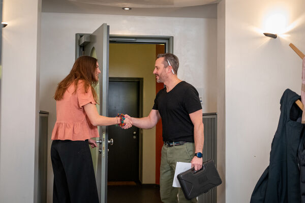 Customer welcoming a tradesperson for a job booked through KnowS